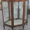 Mid century curio cabinet with glass shelves, decorative back glass and decorative glass door.   Priced 295.00.  
