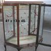 Mid century curio cabinet with glass shelves, decorative back glass and decorative glass door.   Priced 295.00.  