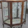 Mid century curio cabinet with glass shelves, decorative back glass and decorative glass door.   Priced 295.00.  